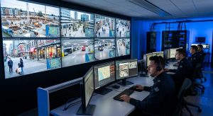 Modern security operations center in Vancouver with guards monitoring CCTV feeds from Lower Mainland properties